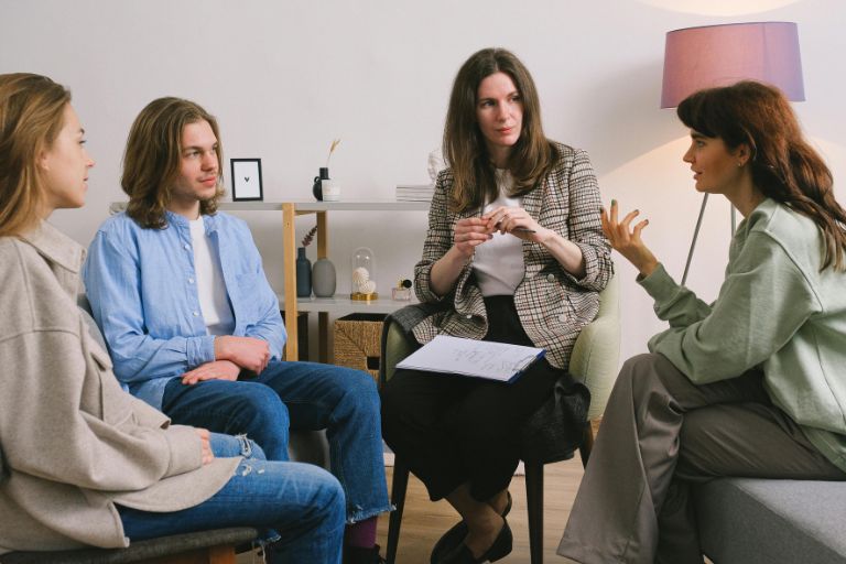 A group of people in a thoughtful discussion, symbolizing the importance of open dialogue and sharing truth in a supportive environment