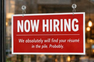 Red now hiring sign on window with humorous text saying 'We absolutely will find your resume in the pile. Probably.' illustrating the challenge of standing out in competitive job applications